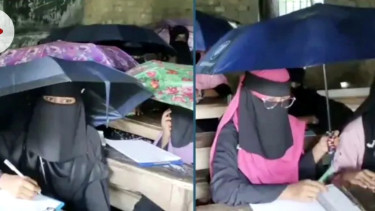 বৃষ্টিতে ছাতা মাথায় পরীক্ষা দিলেন শিক্ষার্থীরা